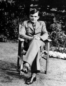 Alan Turing seated.