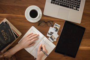 A pen poised to write in a notebook.