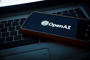 A phone screen displaying OpenAI’s logo