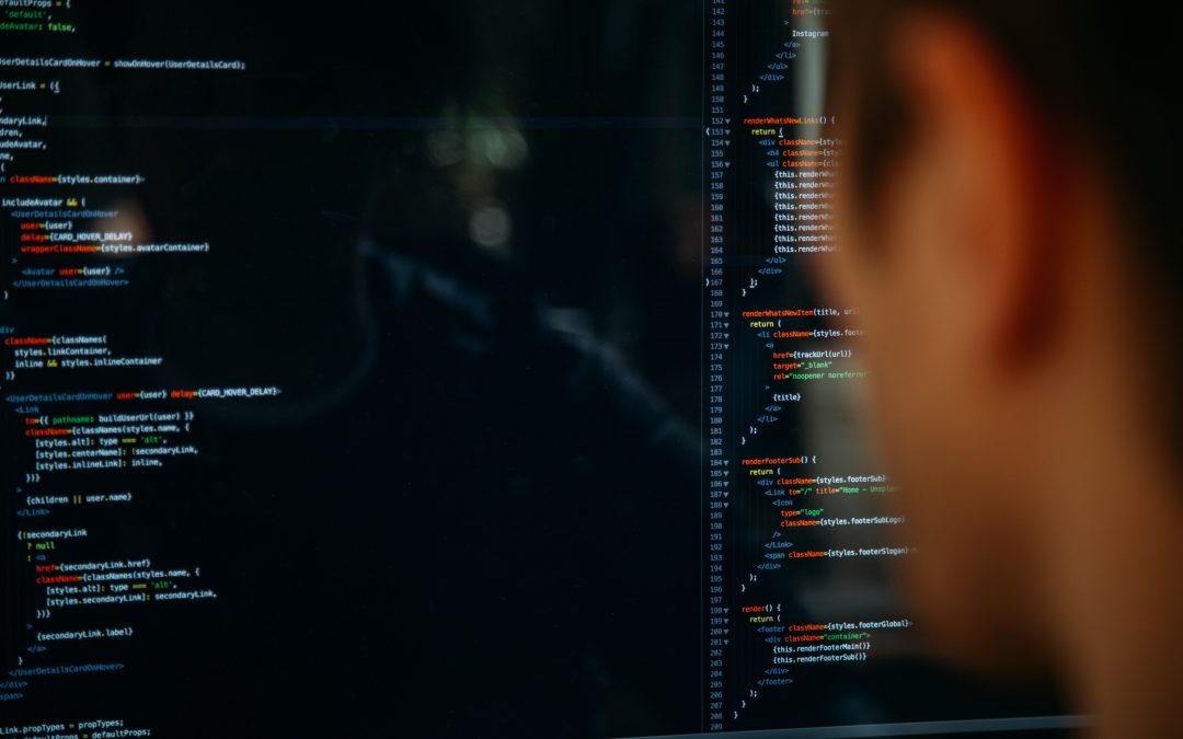 A man looking at a computer screen displaying code