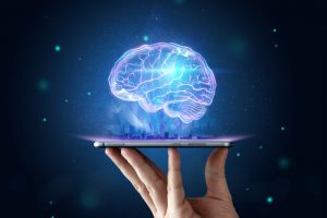 A hologram of the human brain floating above the screen of a mobile phone held by a person