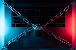 Top view of a laptop keyboard with a chain and a padlock