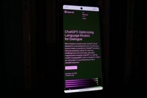 A mobile phone displaying the ChatGPT page on OpenAI’s website
