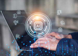 Image of a man using a laptop in the background and an overlay titled “AI” in the foreground